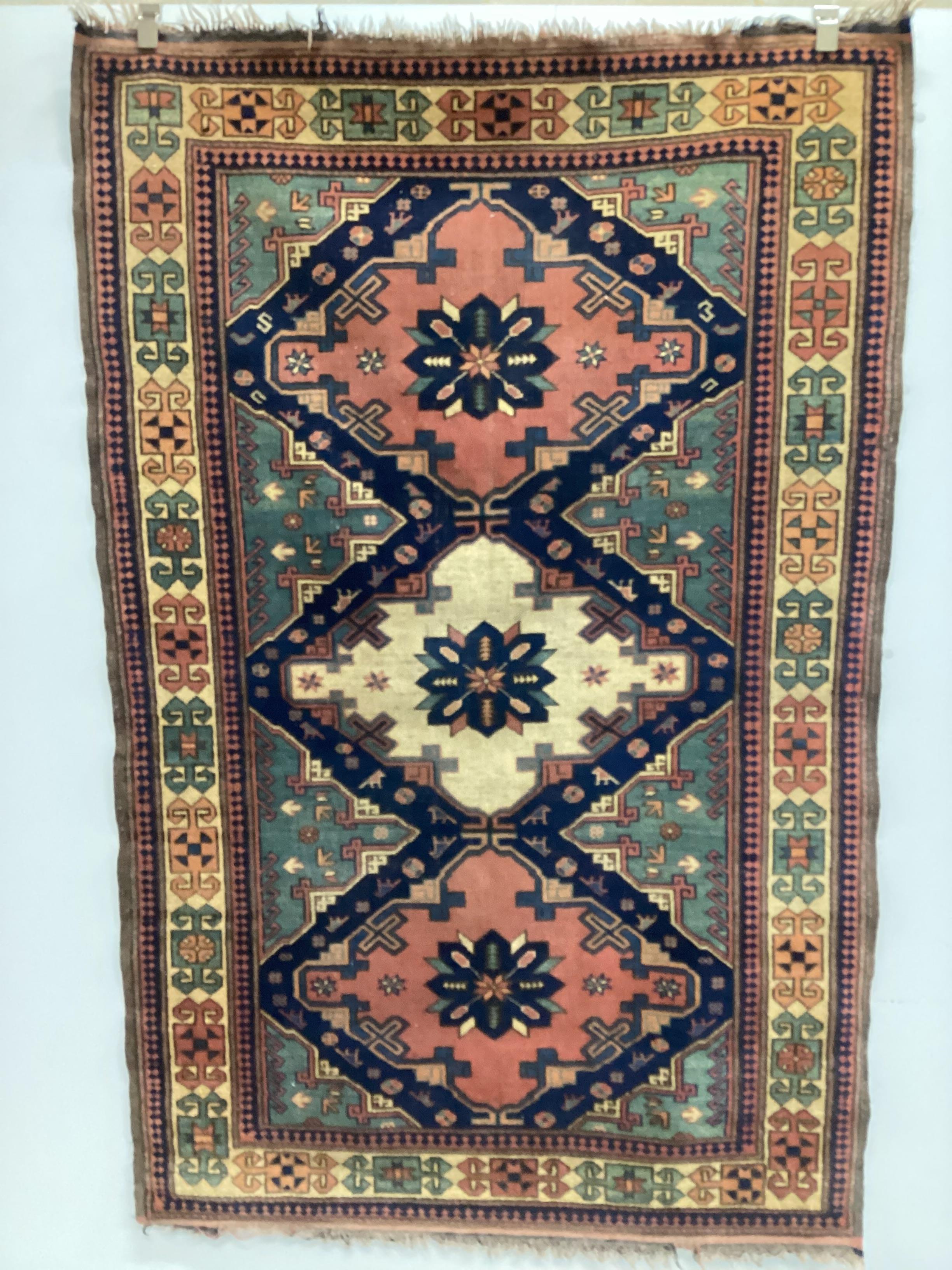 A Caucasian style blue ground triple medallion rug, 200 x 130cm
